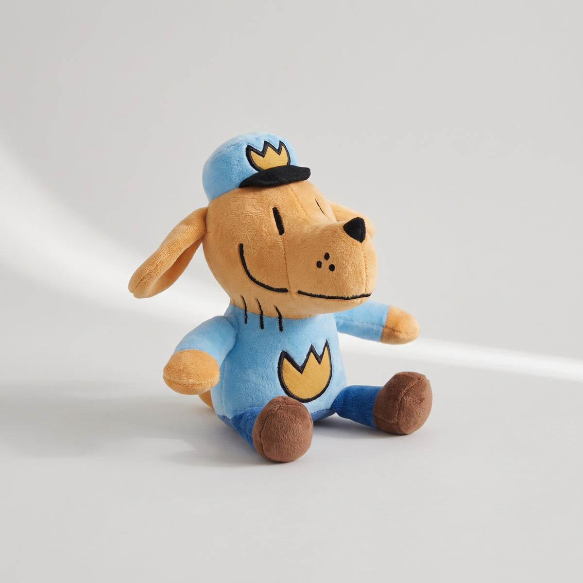 Dog Man Plush Toy, studio photo on a light grey background