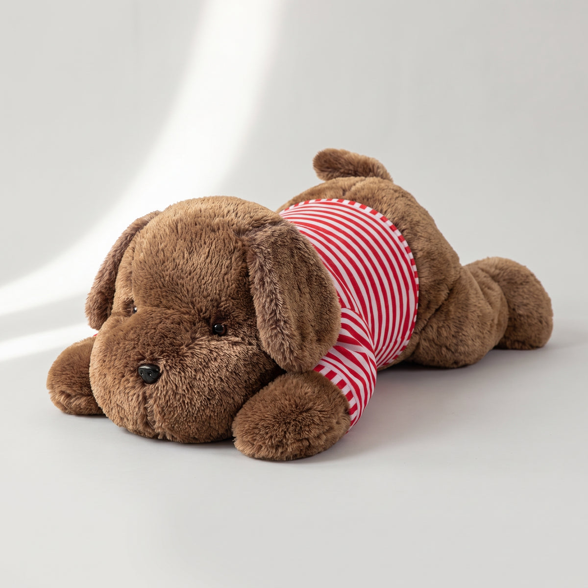 Giant Plush Dog, studio photo on a light grey background