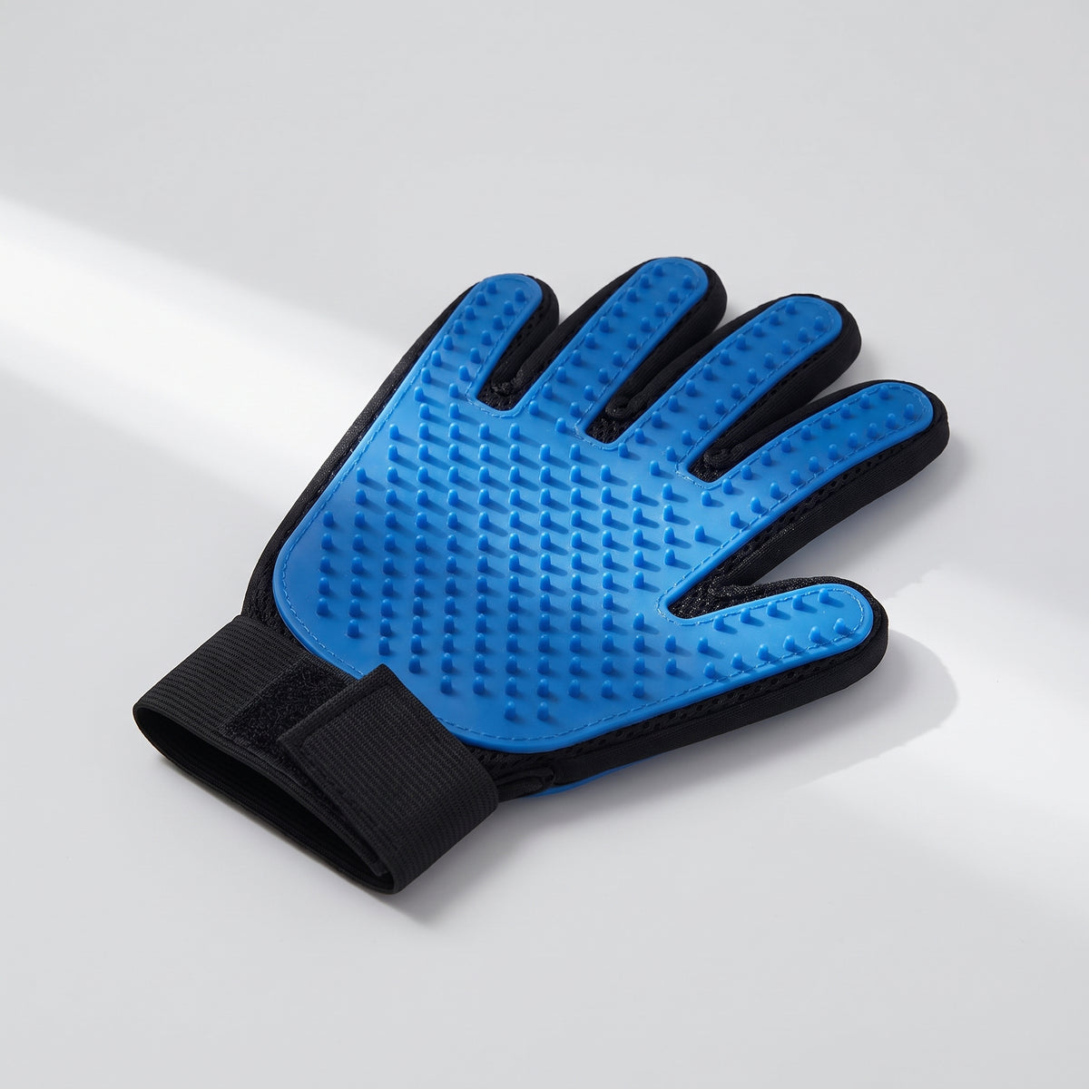 Glove For Brushing Dogs, studio photo on a light grey background