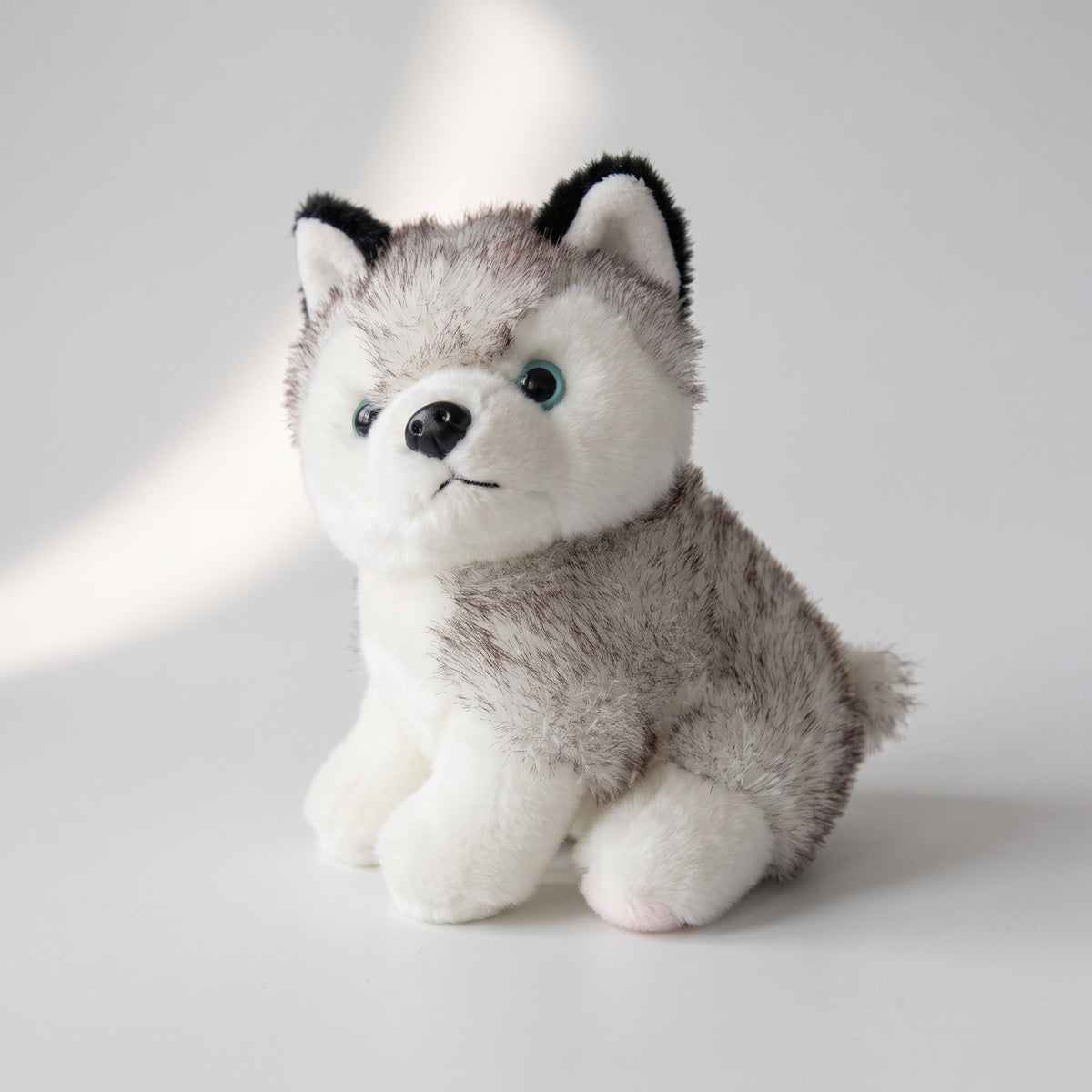 Husky Dog Plush Toy, studio photo on a light grey background