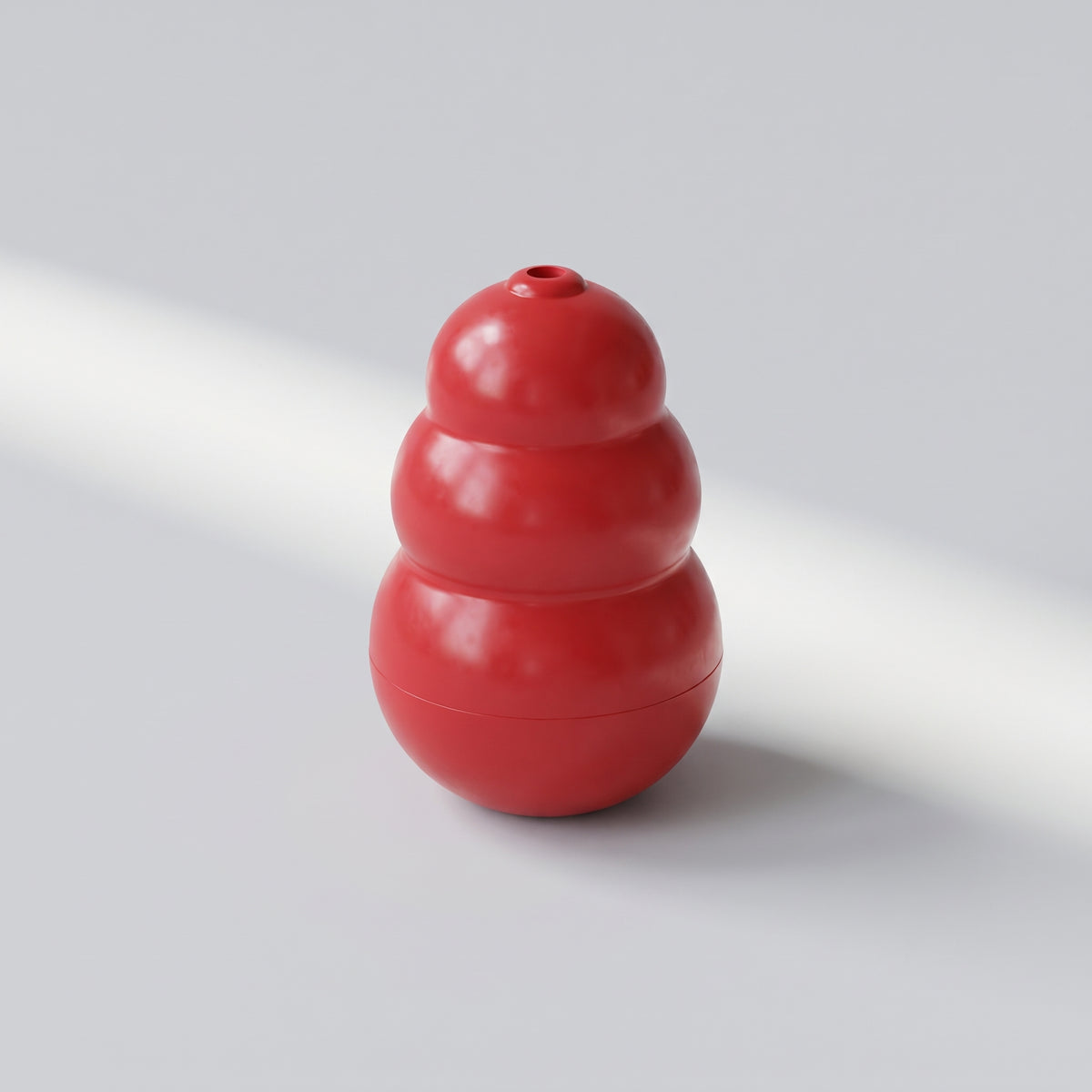 Classic Red Treat Chew Toy for Dogs, studio photo on a light grey background