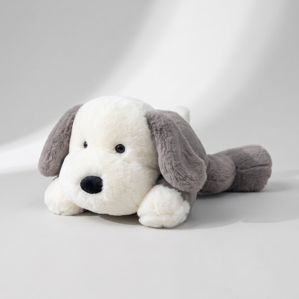 Lying Dog Plush Toy, studio photo on a light grey background