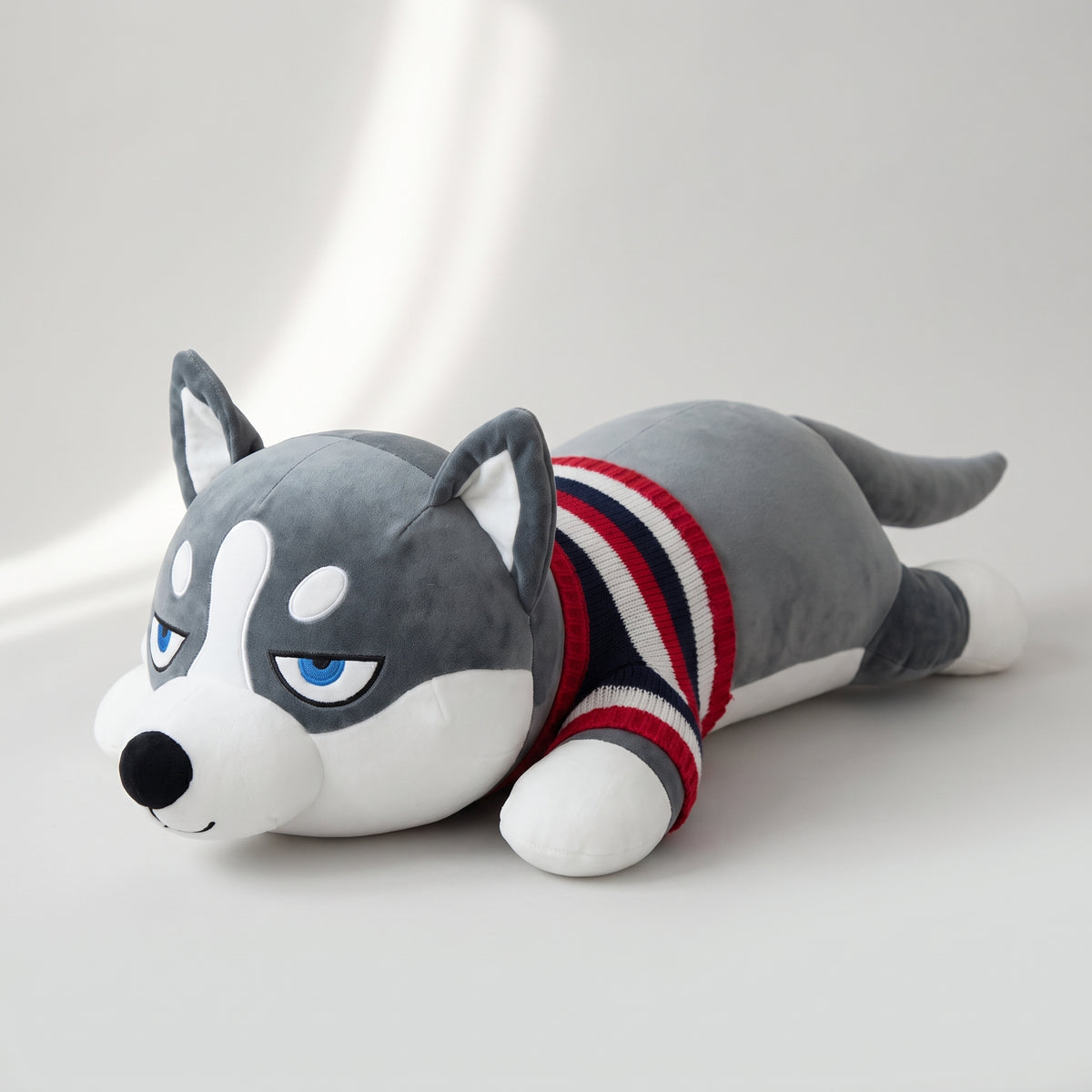 Siberian Husky Plush Toy, studio photo on a light grey background